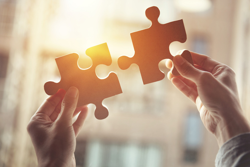 Two puzzle pieces fitting together
