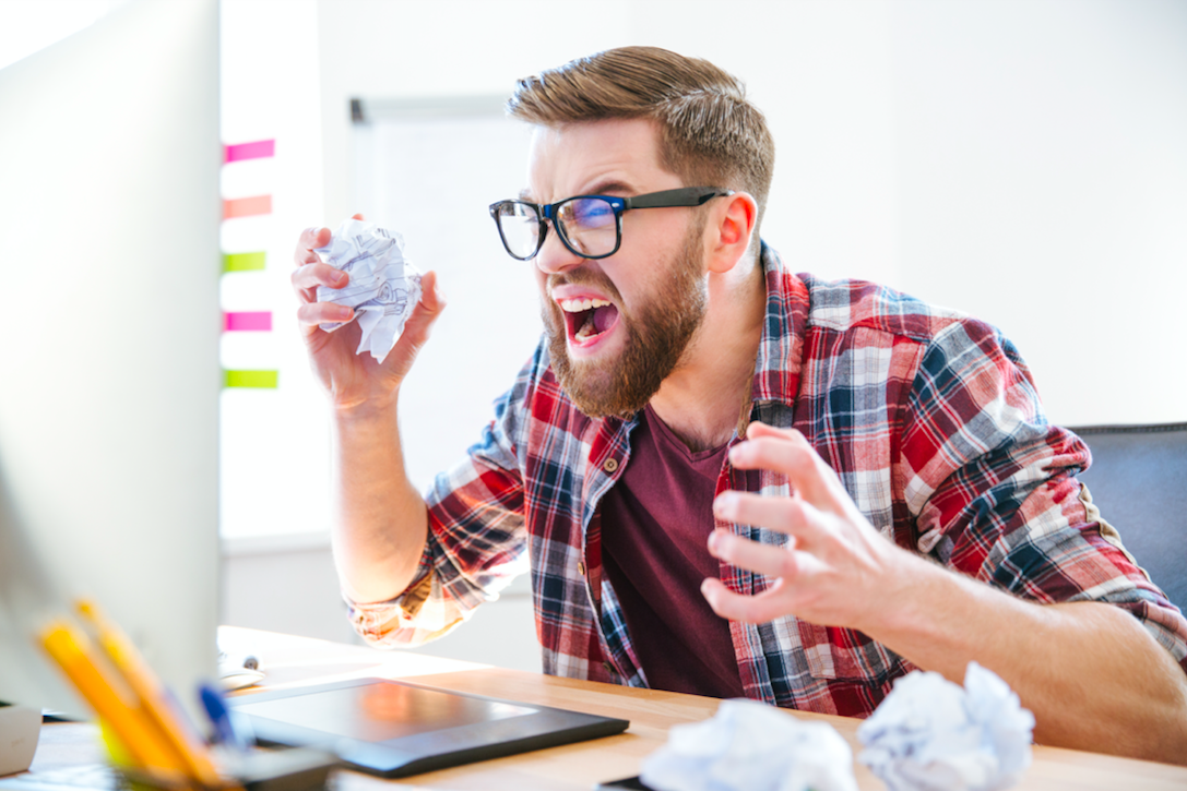 Man frustrated at computer screen