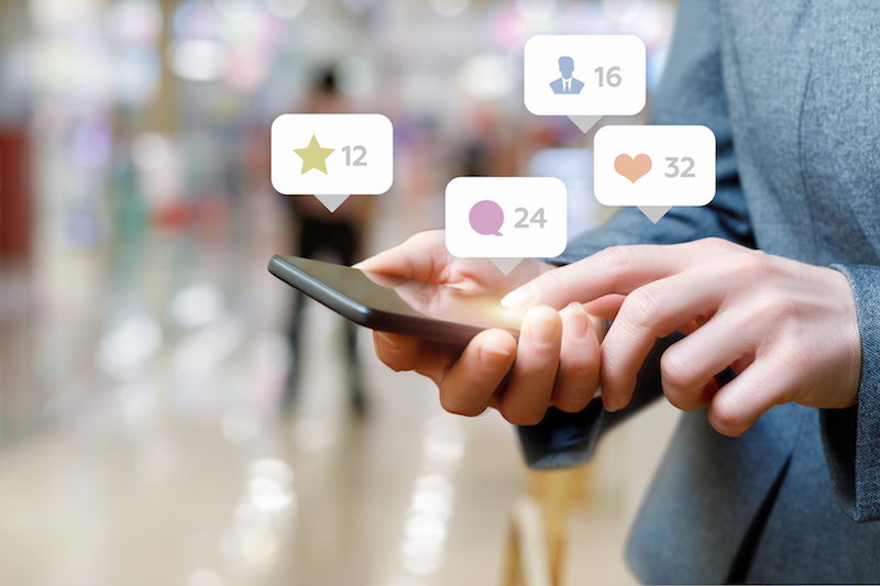 Business woman talking on the social network on blurred background.