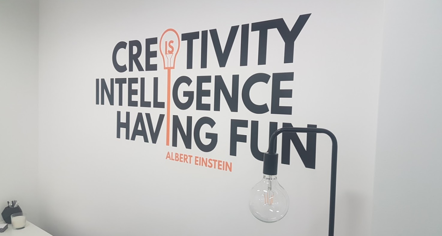 InSentra office workplace - sign saying "Creativity is Intelligence Having Fun"