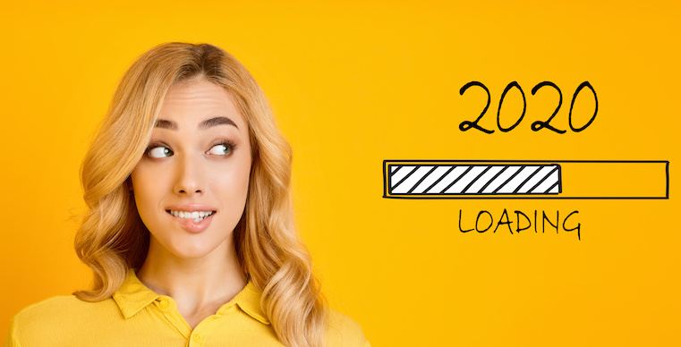 Waiting for new year. Blonde biting her lip and looking at 2020 loading process, yellow panorama background
