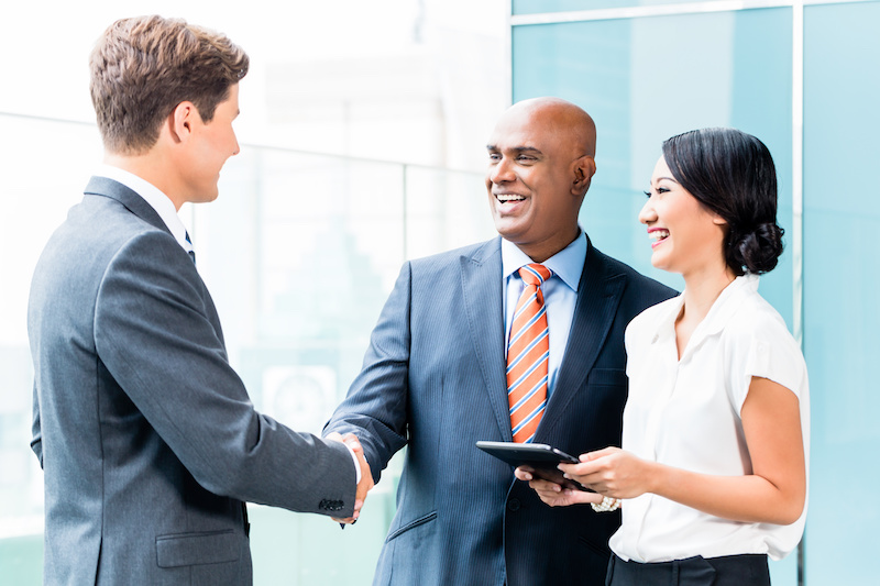 CEO and executive having business handshake in front of city skyline