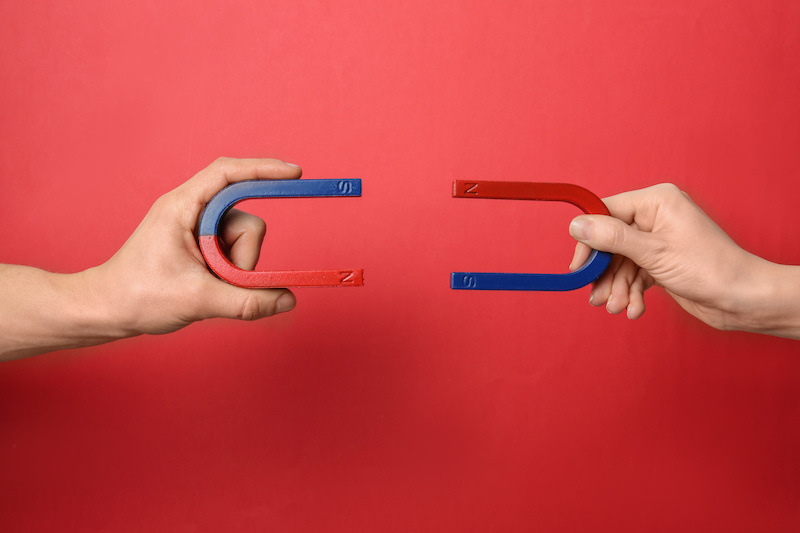 People holding magnets on color background, closeup employer branding