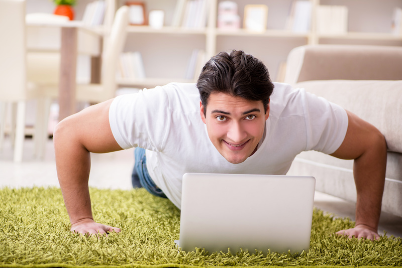 Man working on laptop at home on carpet floor