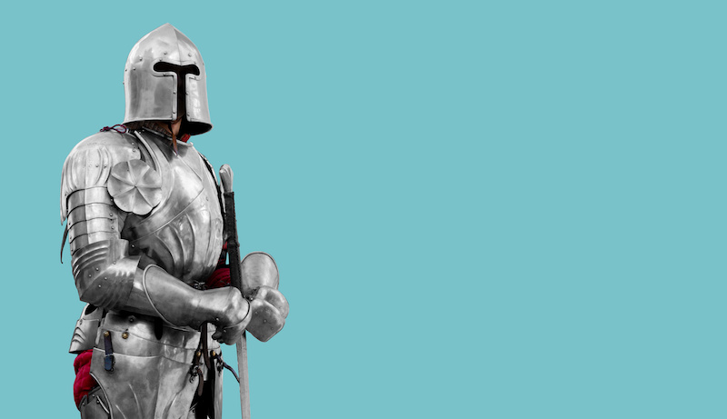 Knight in shiny metal armor. Reliable security and insurance. Copy space.