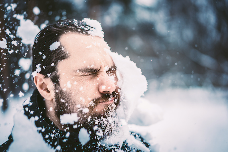 man gets a snowball in the face