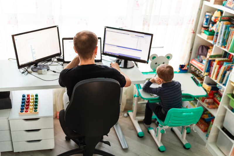 Father working from home with son