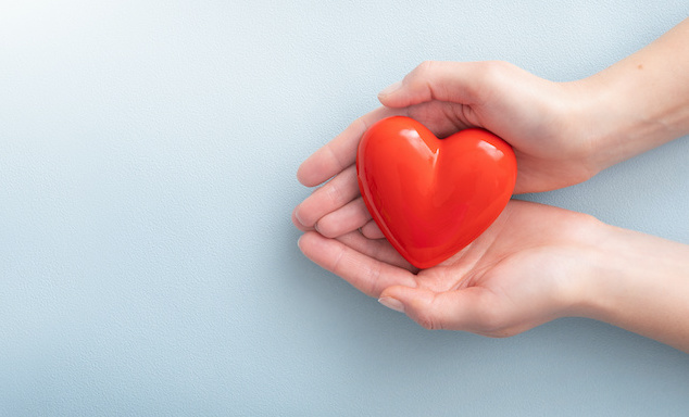 Woman holding a red heart - symbolising empathy ethics in recruitment