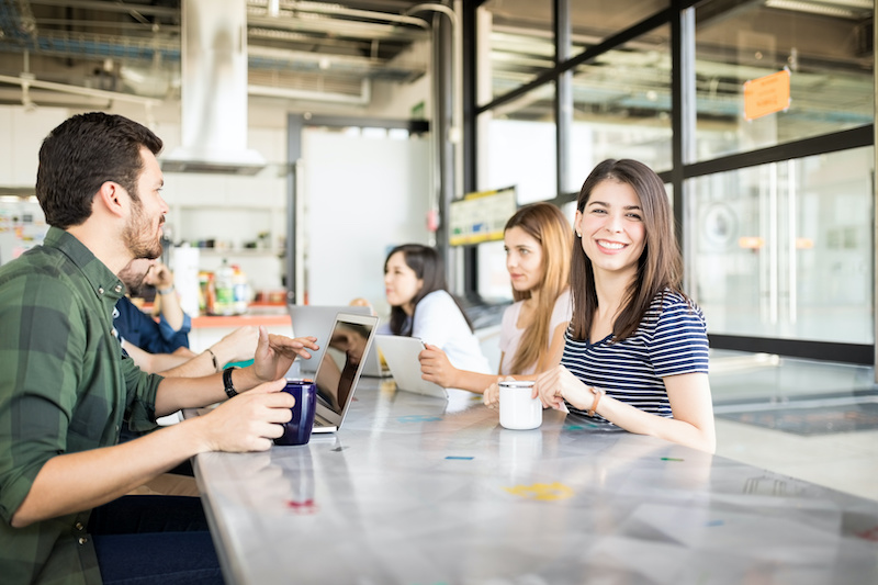 Woman with colleagues at cafeteria