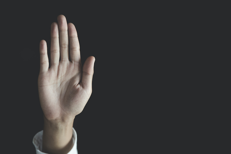 woman raising her hand